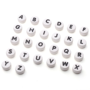 Detailed macro of white round alphabet beads for DIY jewelry making and bracelets