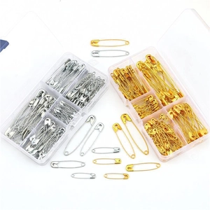 Bulk gold and silver safety pins in a clear organizer box for DIY crafting and clothing