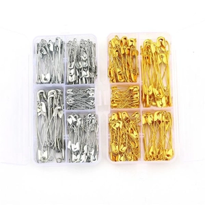 Set of gold and silver vintage safety pins organized in clear multi-grid storage boxes