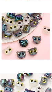 Macro detail of acrylic cat head beads in pearl and metallic colors for DIY jewelry making