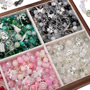 DIY jewelry making kit with colorful glass beads and silver alloy charms in a wooden box