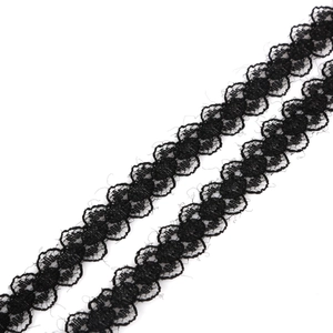 Detailed view of black floral hollow lace ribbon with intricate weave and scalloped edges