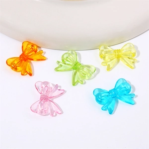 Macro shot of colorful acrylic translucent bow beads for DIY jewelry making and crafts