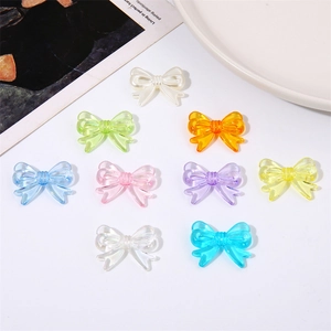 Detailed view of colorful acrylic bow beads for DIY jewelry making and handmade crafts