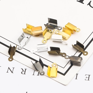 DIY jewelry ribbon crimp ends in gold silver bronze and gunmetal finish on white background