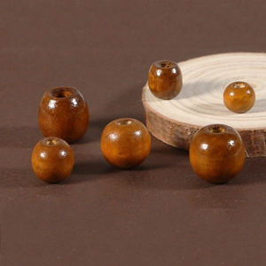 Macro shot of assorted brown wooden beads with visible wood grain and glossy finish