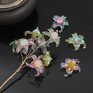 Detail of iridescent acrylic flower charms with golden wire and colorful bead accents