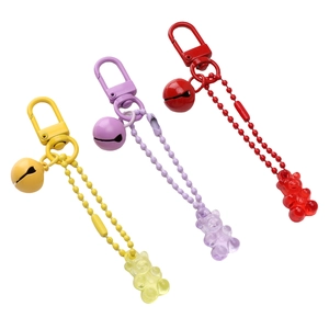 Three colorful acrylic gummy bear keychains with lobster clasps and matching bells