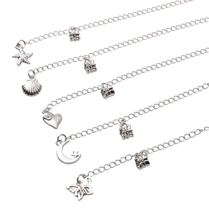 Five pieces of silver metal jewelry chains with starfish shell and moon charms on white background