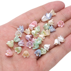 Macro shot of colorful acrylic lily of the valley pearl pendants for DIY jewelry making