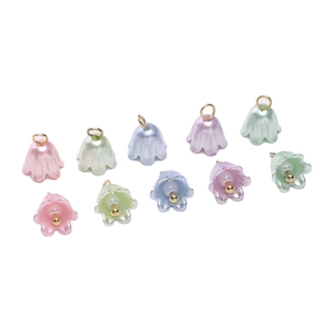 Detailed macro of lily of the valley acrylic flower charms with golden metal loops