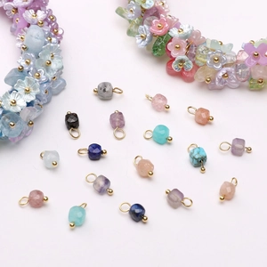 Macro shot of colorful faceted gemstone pendants with elegant gold metal bails for jewelry