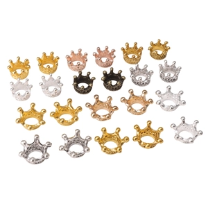 Macro detail of alloy crown charms in gold, silver, and copper for DIY jewelry making
