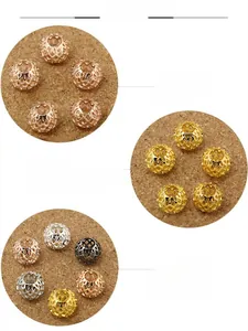 Detailed close-up of hollow metal spacer beads in gold, silver and bronze for DIY jewelry