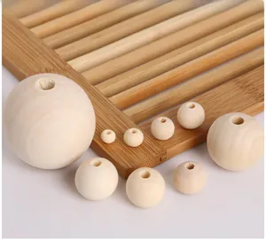 Macro shot of unfinished natural pine wood beads with drill holes for DIY jewelry