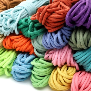 Close-up detail of multi-colored braided cotton ropes showing texture for DIY crafts