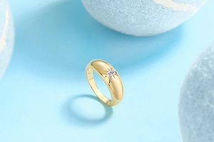 Macro detail of gold S925 silver ring featuring marquise moissanite and starburst engraving