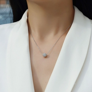 Elegant S925 sterling silver necklace with a round moissanite pendant on a professional model
