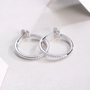 Detailed close-up of S925 sterling silver hoop earrings with sparkling moissanite stones