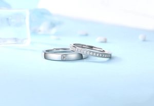 Close-up of S925 silver couple rings featuring a square cut stone and micro-pave setting
