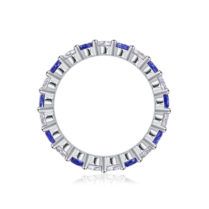 Close-up of S925 silver eternity ring with alternating blue and white gemstones