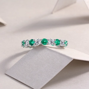 Macro shot of S925 silver ring featuring alternating green and white gemstones