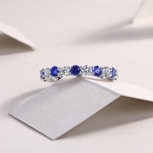 Macro shot of S925 sterling silver eternity ring with blue gems and clear diamonds
