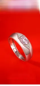 Macro shot of S925 silver adjustable ring with oval pink moissanite on red silk