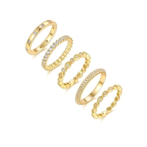 Macro detail of five assorted gold-plated S925 silver rings with sparkling zircon inlay