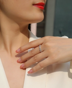 Detail of S925 silver marquise-link ring with moissanite stones on finger