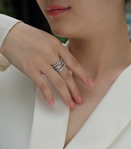 Close-up of a multi-layer S925 silver crisscross ring with micro-pave moissanite stones