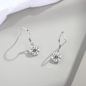 Macro shot of S925 sterling silver hook earrings with moissanite round cut stones