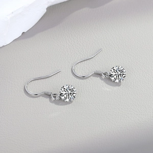 Macro detail of S925 sterling silver drop earrings with brilliant round cut moissanite