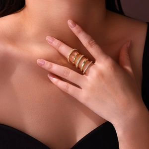 Close-up of five-piece gold ring set with cubic zirconia stones on model finger