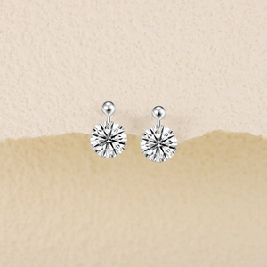 Macro shot of sparkling round cut moissanite earrings in S925 sterling silver hooks