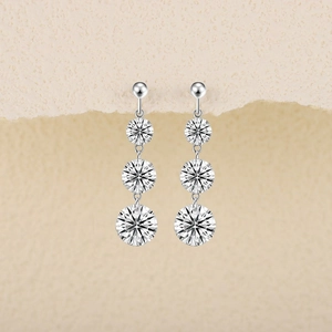 Detail of S925 sterling silver drop earrings with three graduated round cut stones