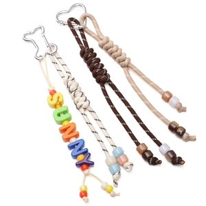 Detail of handmade paracord keychains with colorful SUNNY letter beads and metal clasps