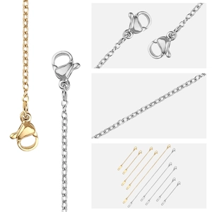 Detail view of gold and silver stainless steel extension chains with lobster clasps