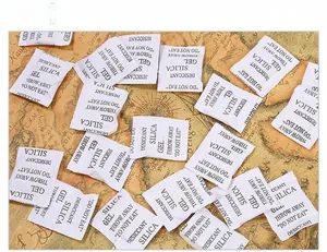 Macro detail of white silica gel desiccant packets on a vintage map for moisture protection