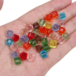 Colorful cube glass crystal beads for DIY jewelry making held in hand for scale
