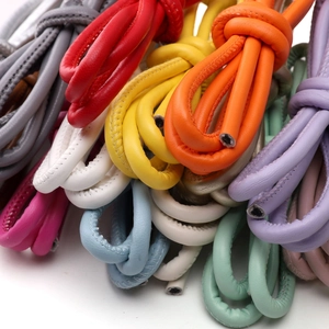 Macro detail of 6mm colorful faux leather cords with high-quality stitching for DIY crafts