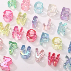 Macro view of iridescent acrylic alphabet beads with large holes for DIY jewelry making