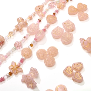 Pink glass bead kit for DIY jewelry featuring gold etched heart and butterfly charms