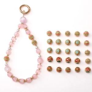 Detail of DIY phone lanyard kit with pastel beads and Cloisonne lucky charm spacers