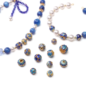 DIY jewelry kit with blue enamel cloisonné beads and gold floral charms for crafting