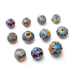 Detailed macro view of 11 handcrafted blue cloisonne enamel beads for DIY jewelry making