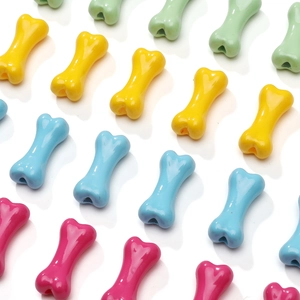 Close-up of colorful bone-shaped acrylic beads with glossy finish for DIY jewelry