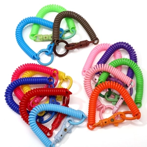 Close-up of colorful elastic plastic spring keychains with rotating hooks for DIY crafts