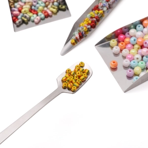 Macro shot of colorful resin beads with metal scoops for DIY jewelry making sets