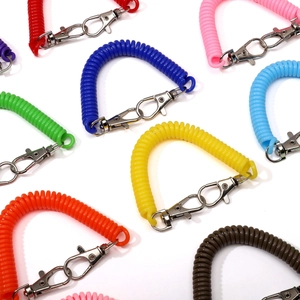 Multi-color plastic spiral coil keychain with dual silver lobster clasps on white background